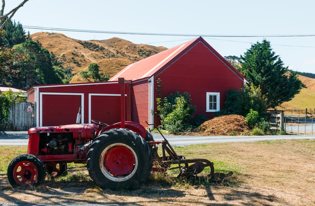 Red tractor and red shearing shed.
