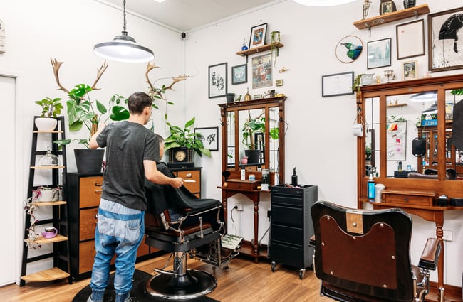 A barber cutting a client's hair.