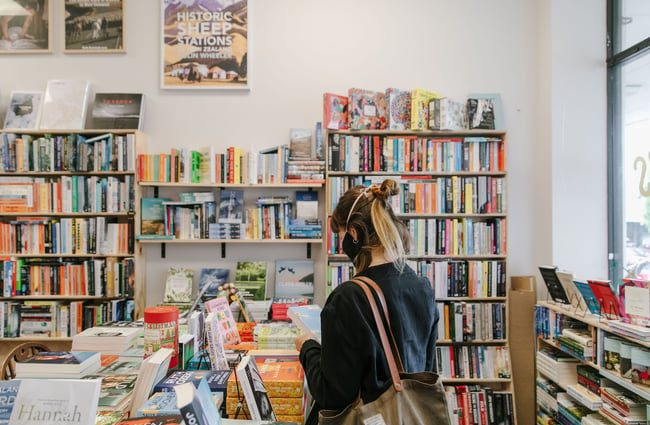Woman browsing books at Bay Hills Books in Timaru, New Zealand.