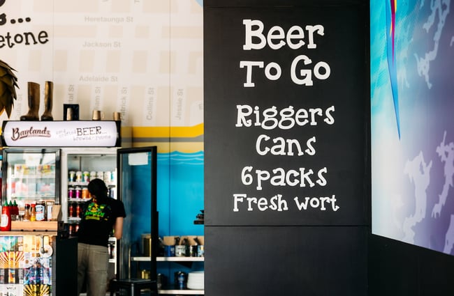 Sign advertising beers to go, riggers and cans