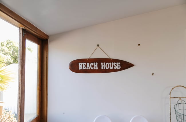 Beach House sign hanging on the wall.