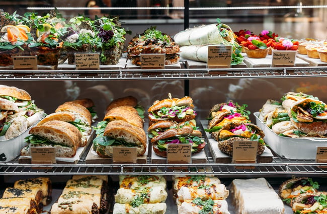 Rows of food in a glass cabinet.