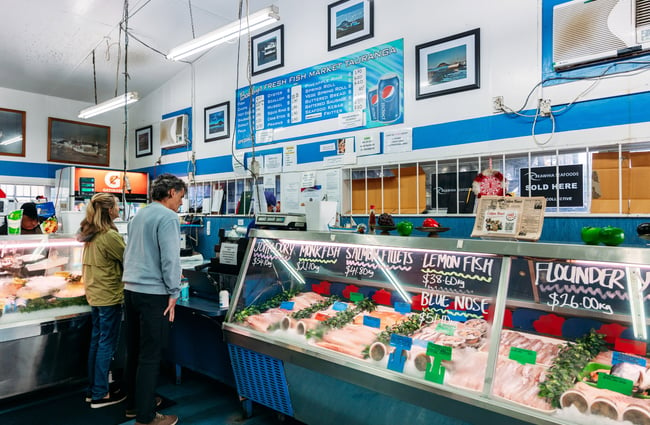 Customers waiting in line to be served at a fish supply store.