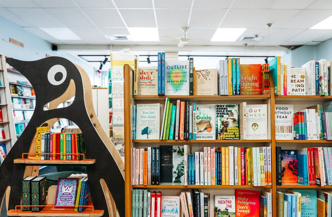 Books on display next to a penguin cut out.