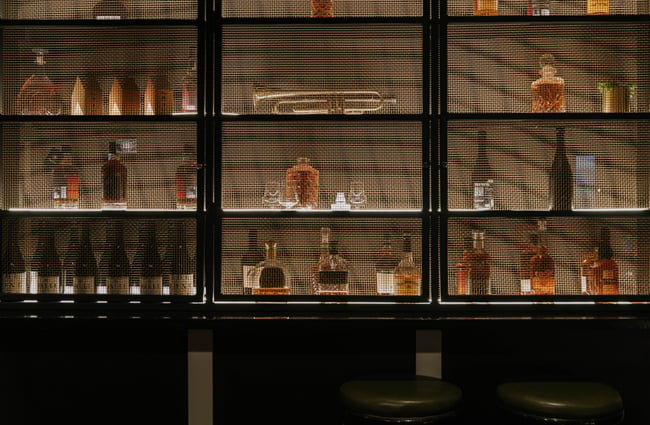 Wall of cabinets filled with alcohol bottles.