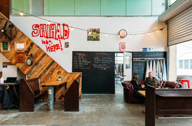 The interior of the Bootleg Brewery with red graffiti on the wall.