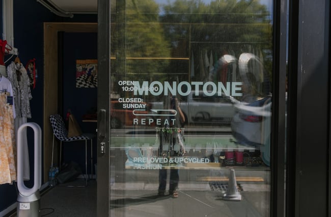 Looking in the open glass door of Monotone, a preloved fashion boutique in BOXed Quarter in Christchurch.