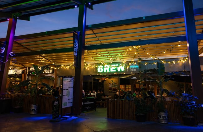 The neon green BREW sign illuminated in the distance.