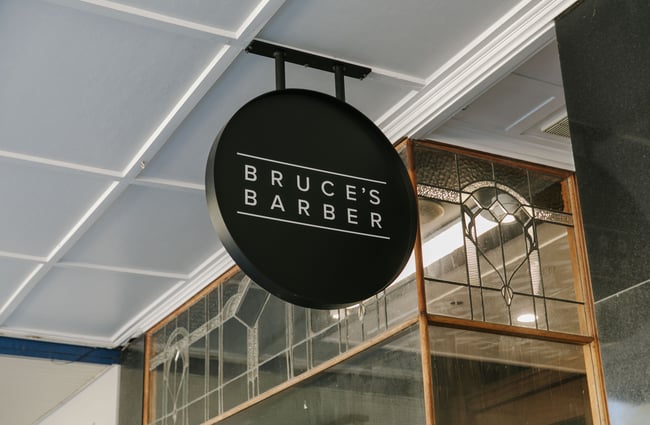 A close up of the exterior 'Bruce's Barber' sign.