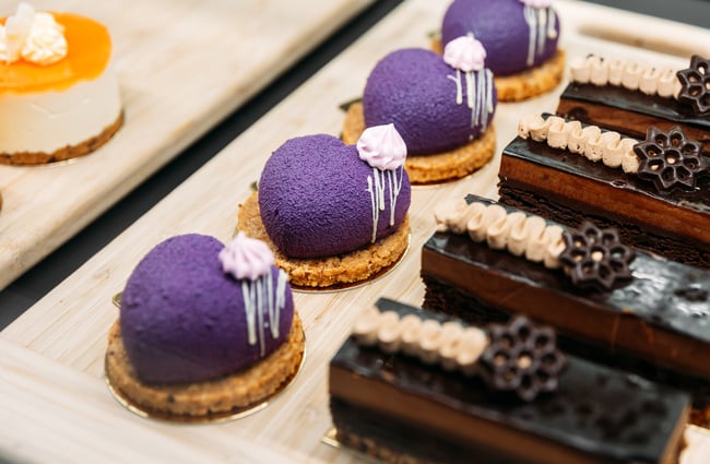 A close up of chocolate and purple desserts.