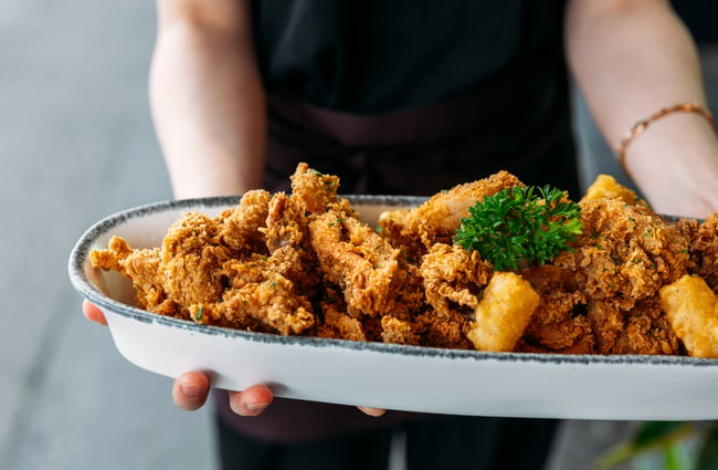 A close up of fried chicken on a plate.