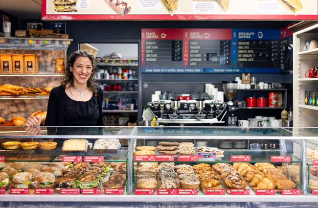 A woman smiles behind the counter at Ciabatta.