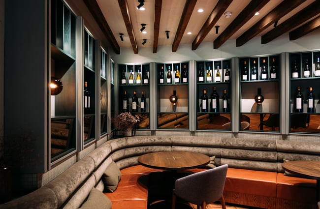 A corner nook in the Craggy Range restaurant with bottles of wine in cabinets behind.