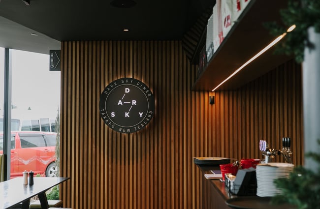 Dark Sky Diner logo on wood panelling in Tekapo.