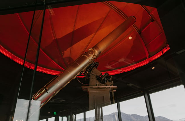 Telescope under red light at Dark Sky Diner, Tekapo.