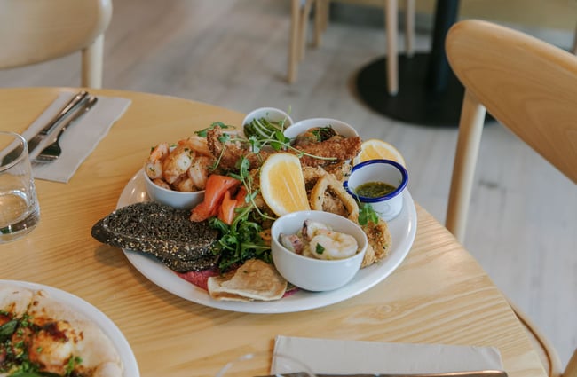 A plate overflowing with different types of sea food.
