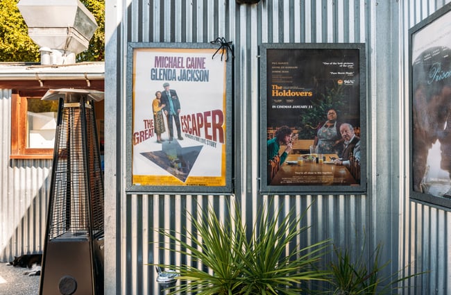 Movie posters on display on the exterior of a building.