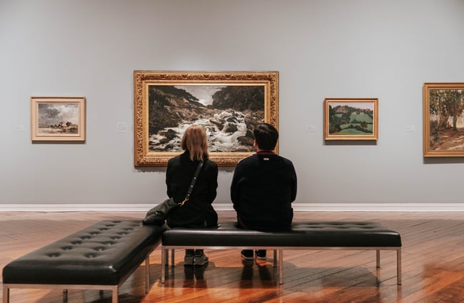 Two people looking at art.