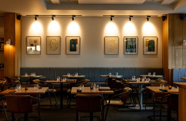 Contemporary interior of Earl in Christchurch with modern art on the walls and tables set for dining service