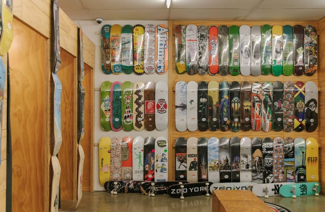 The back wall at Embassy covered in hanging skateboard decks.