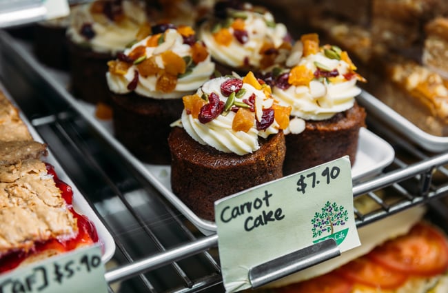 Mini carrot cakes on a cafe counter.