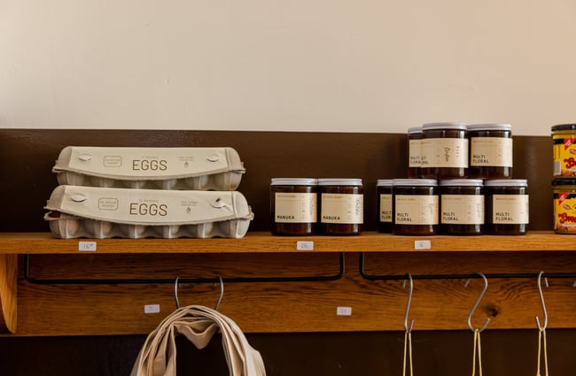 Eggs and jam for sale on floating shelves.
