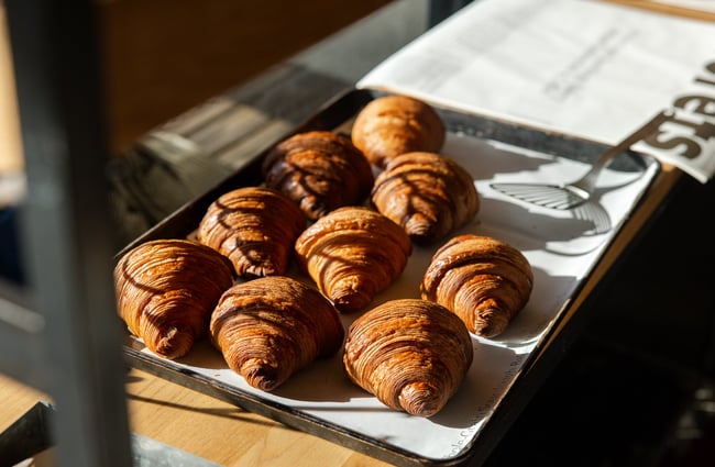 A close up of croissants on a tray in the window at Florets Auckland.