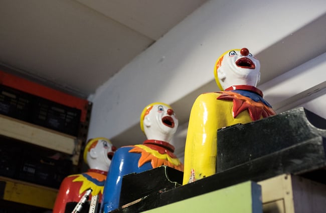 Colourful clowns with their mouths open.
