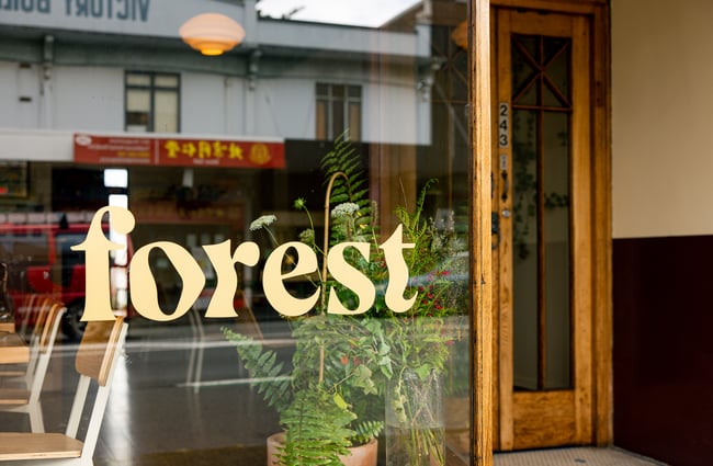 A close up of the word 'Forest' on a window.