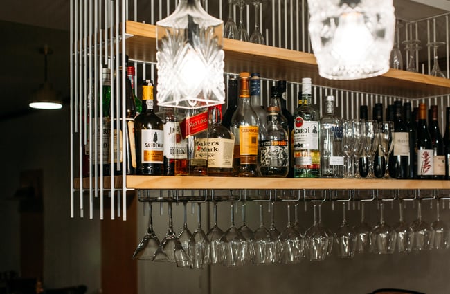 Drinks and spirits on a shelf above the bar at Fork N Knife, New Plymouth.