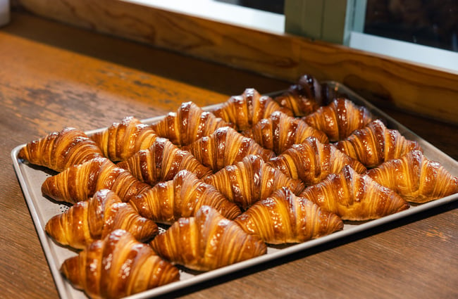A tray of baked croissants on a tray.
