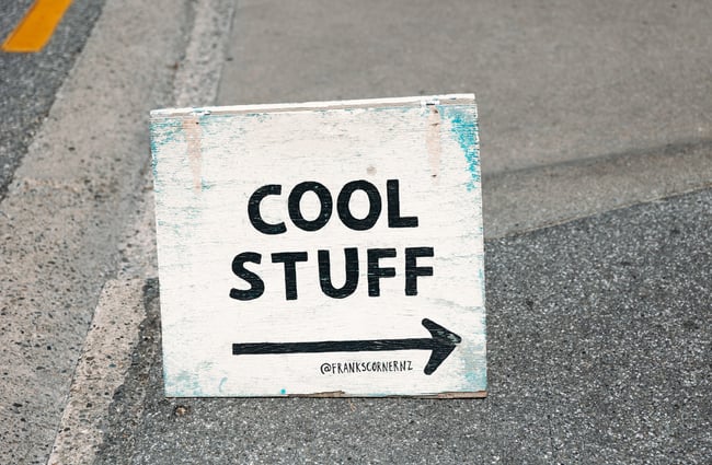 A sign that says 'Cool Stuff' on the pavement.