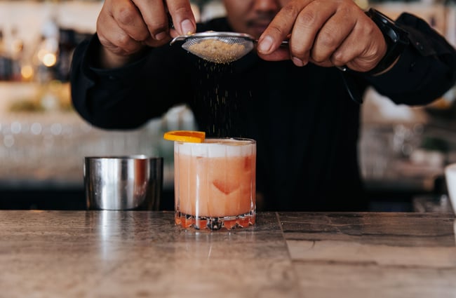 Close up of a cocktail being made inside the bar.