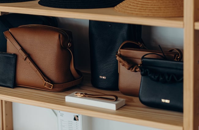 A close up of brown and black leather bags.