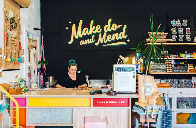A woman working behind the counter at Good Housekeeping Wellington shop, New Zealand.
