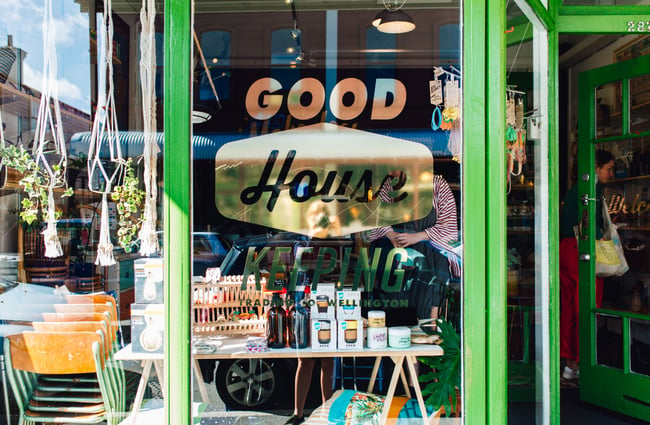 The entrance to the shop and window signage outside Good Housekeeping Wellington shop, New Zealand.