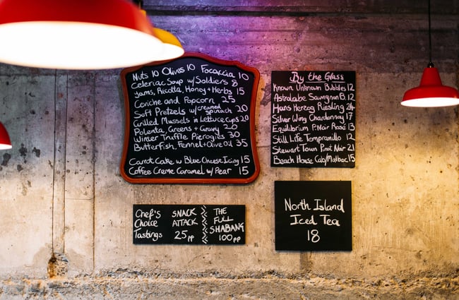 A close up of blackboard menus on the wall.