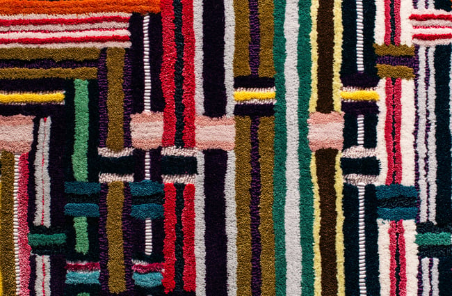 An extreme close up of a colourful rug.
