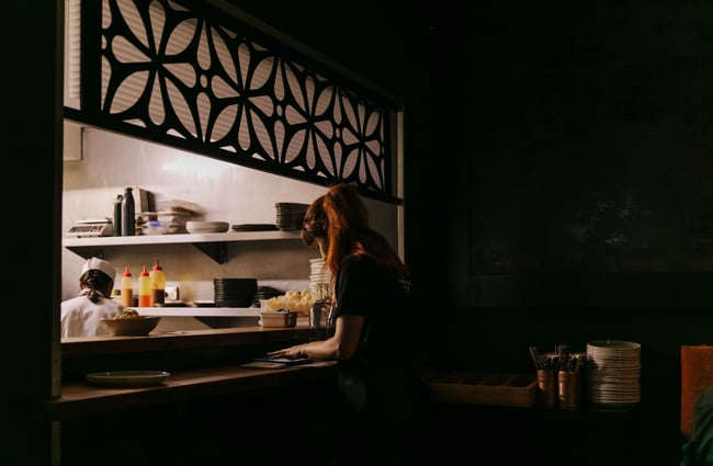 Woman standing at the pass of the kitchen at Harry's Hawker House.