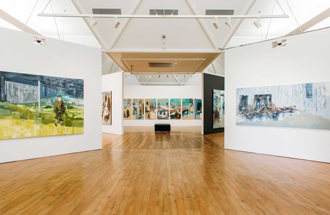 Massive paintings on multiple walls inside Hastings City Gallery.