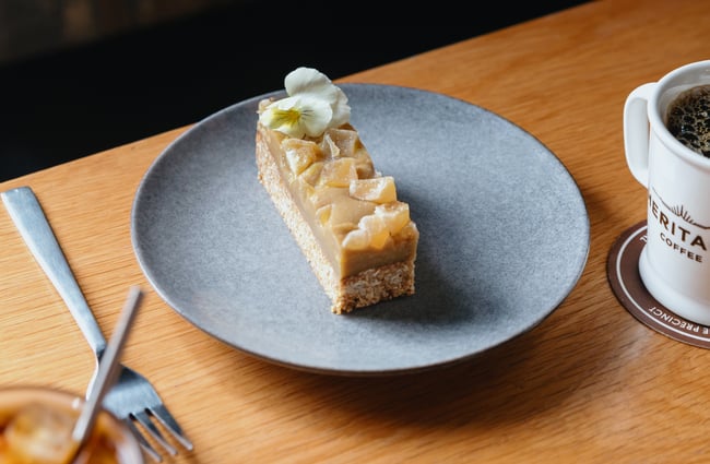 A plated piece of ginger slice on a table.