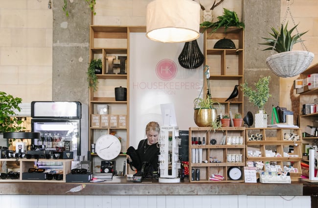 Woman behind the counter at Housekeepers Design in Ōamaru.
