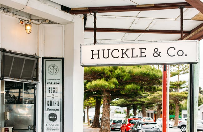 Exterior signage attached to the roof that says 'Huckle & Co'.