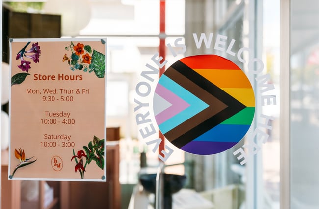 A rainbow window stickers that says everyone is welcome in their store.
