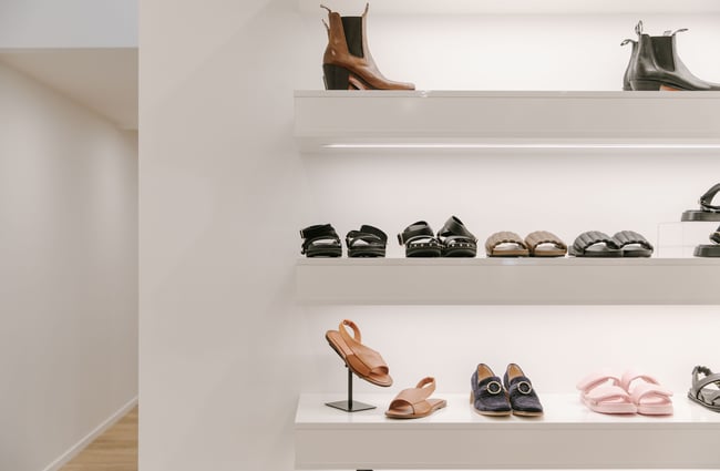 A close up of shoes on white shelves inside Hyde Boutique Oamaru.