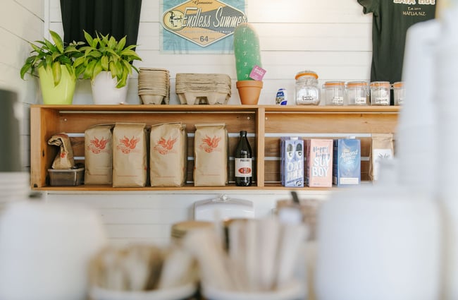 Coffee beans and milk cartons on a shelf at Java Hut, Māpua.