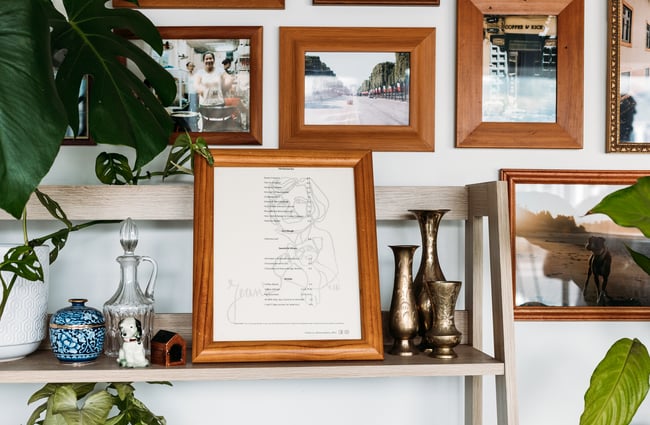 Framed pictures on a white wall.
