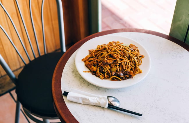 A close up of a plate of noodles on a table.