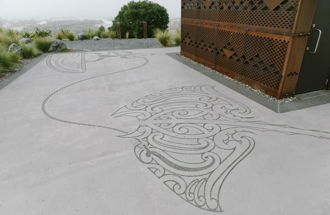 Māori artwork etched on the pathway.