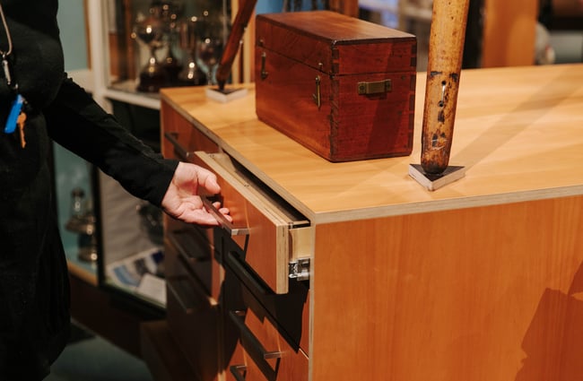 Hand pulling a drawer open at Kaikōura Museum.
